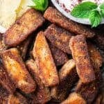 halloumi fries with a side of yogurt mint sauce and lemon wedges