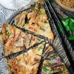 four slices of Korean scallion pancakes with soy dipping sauce and chopsticks