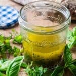 white balsamic vinaigrette in a jam jar and fresh herbs on the side