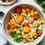 mediterranean pearl couscous salad with mint and halloumi in a bowl.