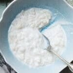 rice pudding with a spoon in a blue bowl.