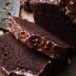 slices of chocolate loaf cake with chocolate almond glaze (rocher glaze).