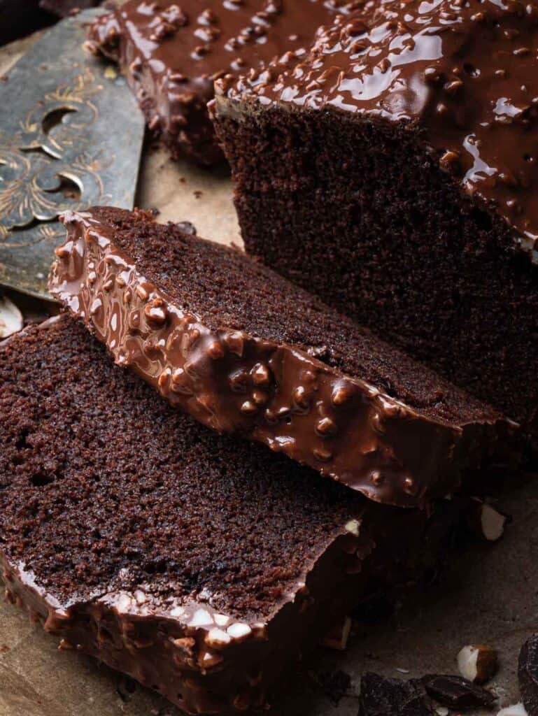 slices of chocolate loaf cake with chocolate almond glaze (rocher glaze).