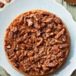 pecan upside down cake on a light blue serving platter.