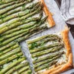 asparagus ricotta tart with puff pastry, with a slice cut off.