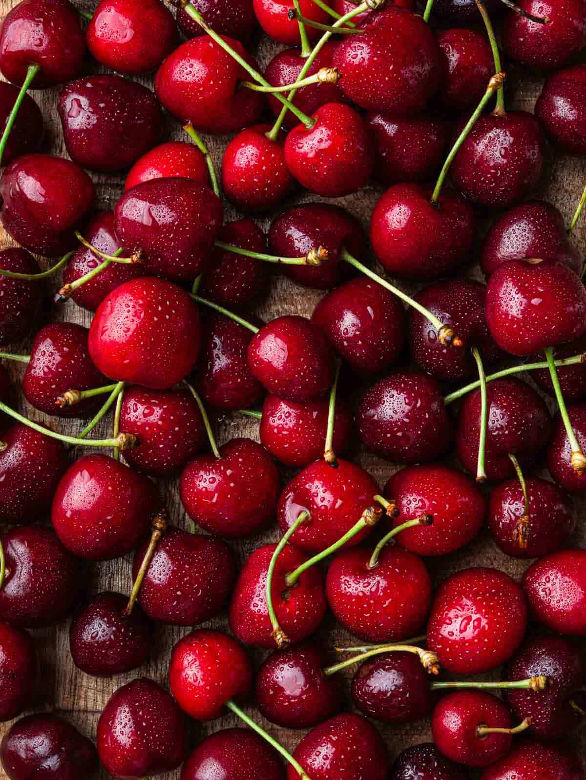 red fresh cherries with water mist on top.