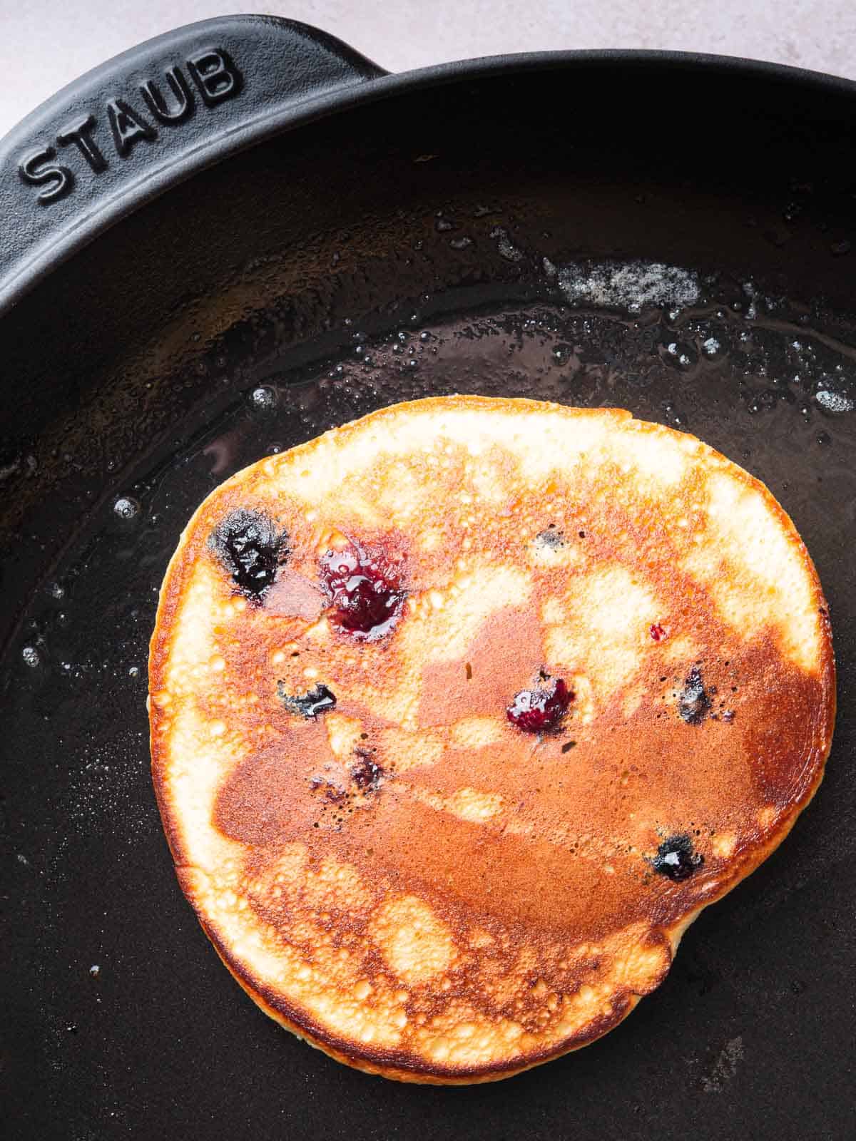 golden blueberry lemon pancake in a pan.