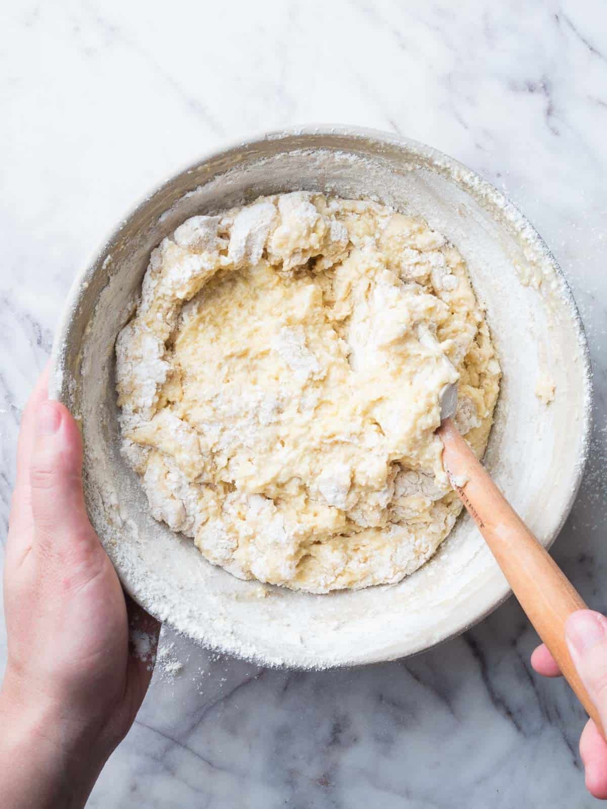 folding dry ingredients to lemon ricotta cake batter.