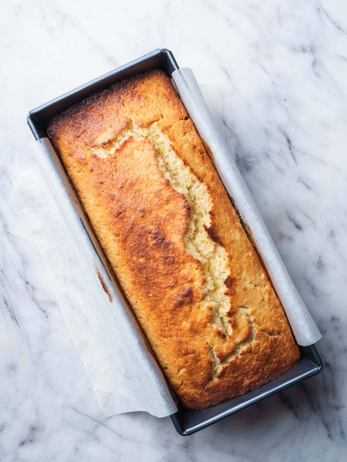 baked lemon ricotta pound cake in a pan.