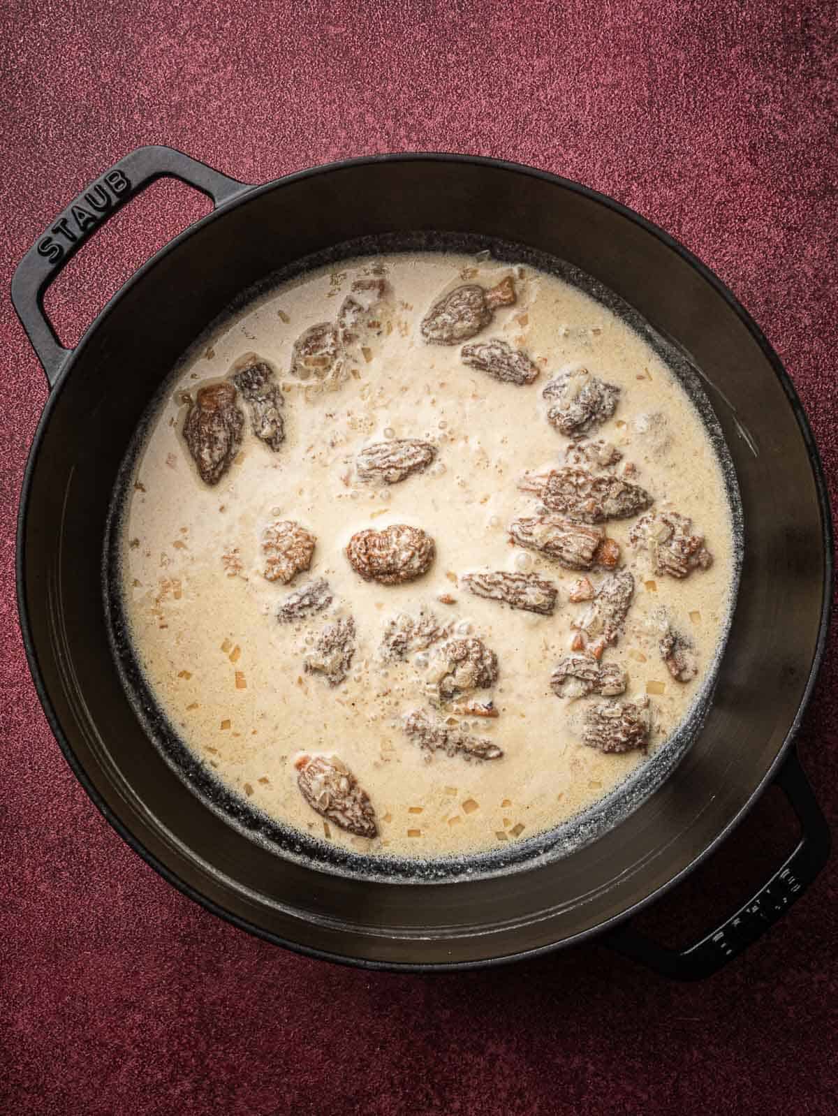 morel and cream pasta sauce in a sauté pan.