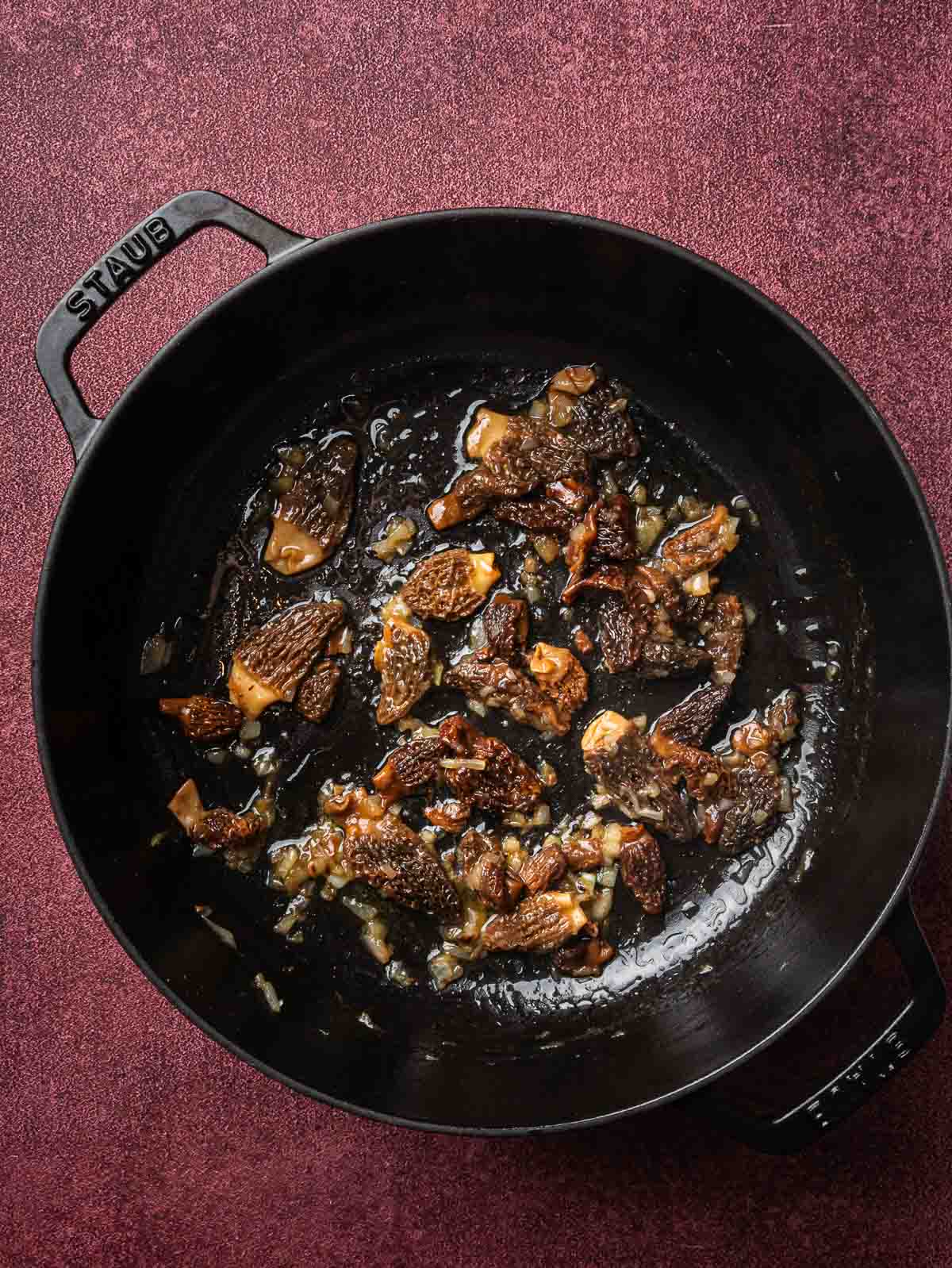 sautéed shallots and morel mushroom in a sauté pan.