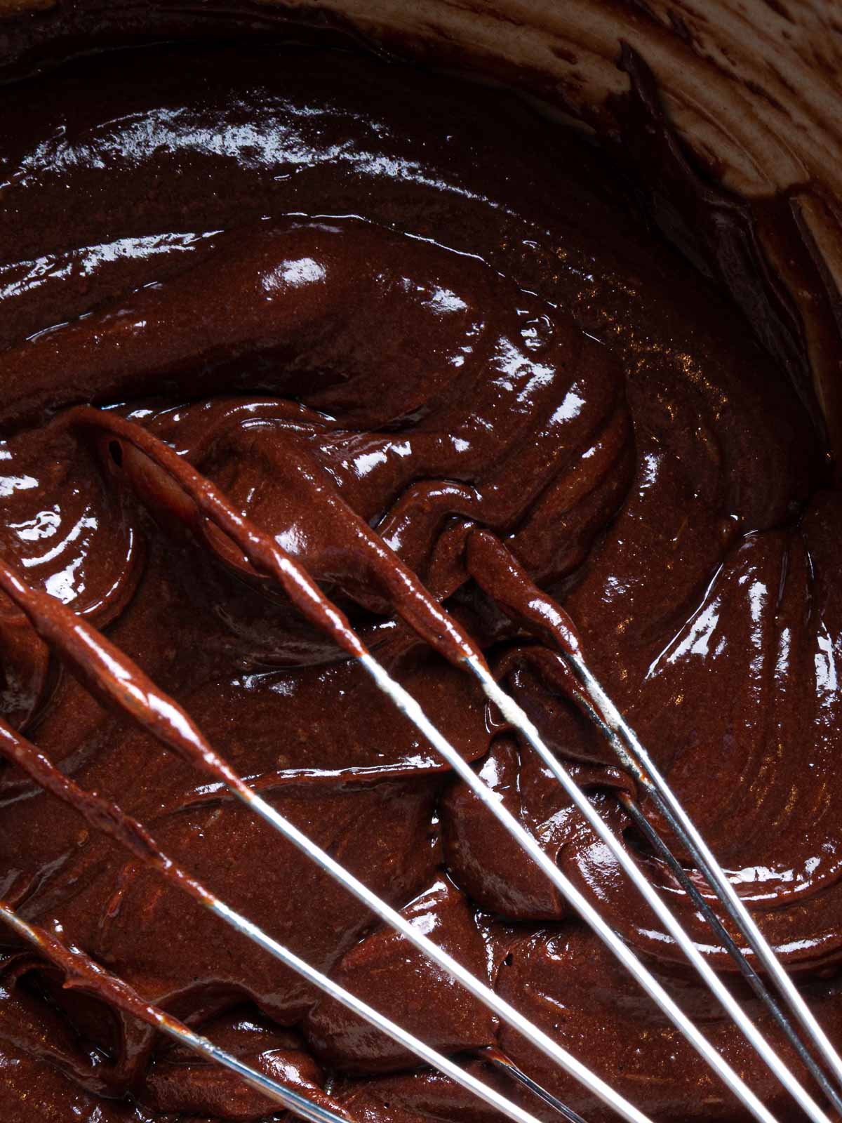 Chocolate lava cake batter with a whisk.