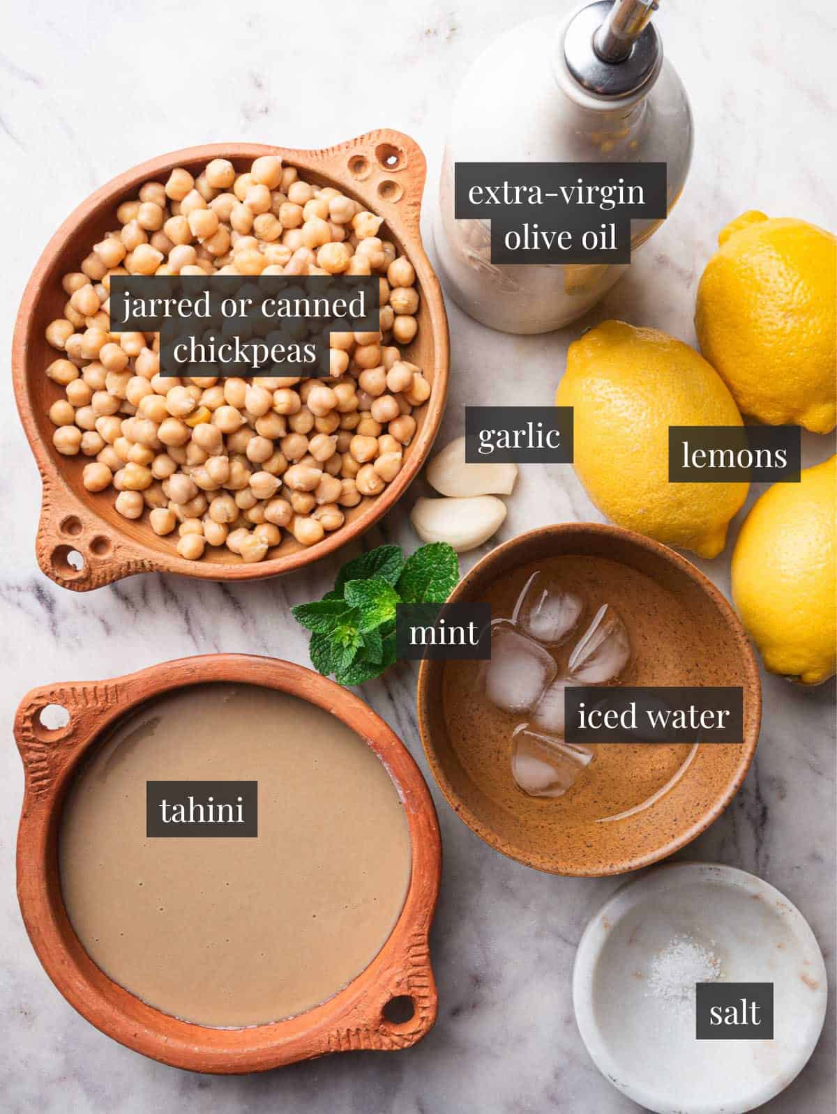 Chickpeas, tahini, lemons, olive oil, garlic, mint, iced water and salt.